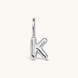 Nadare Co. silver-toned bubble initial charm in the shape of the letter K with a puffed, rounded design.