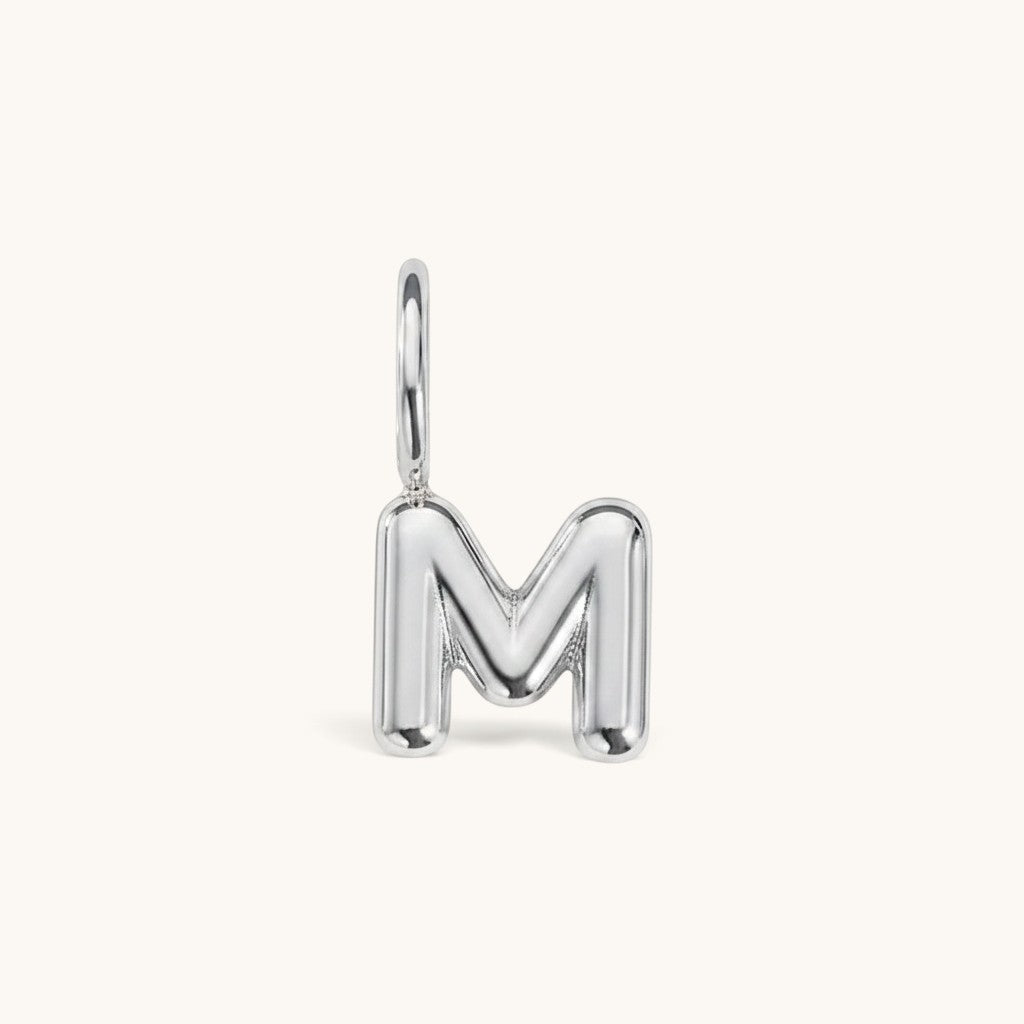 Nadare Co. silver-toned bubble initial charm in the shape of the letter M with a rounded, puffed design.