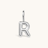 Nadare Co. silver bubble initial charm in the shape of the letter R with a rounded, puffed design.