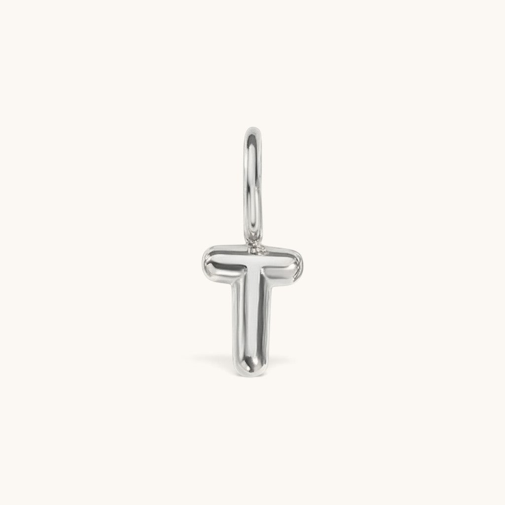 Nadare Co. silver-toned bubble initial charm in the shape of the letter T with a smooth, puffed design.
