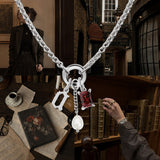 Nadare Co. silver Dark Academia necklace with a ruby-red crystal, freshwater pearl, and initial charm on a switch chain