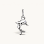 Nadare Co. silver-toned dolphin charm with a sparkling cubic zirconia eye, featuring a sleek leaping silhouette.