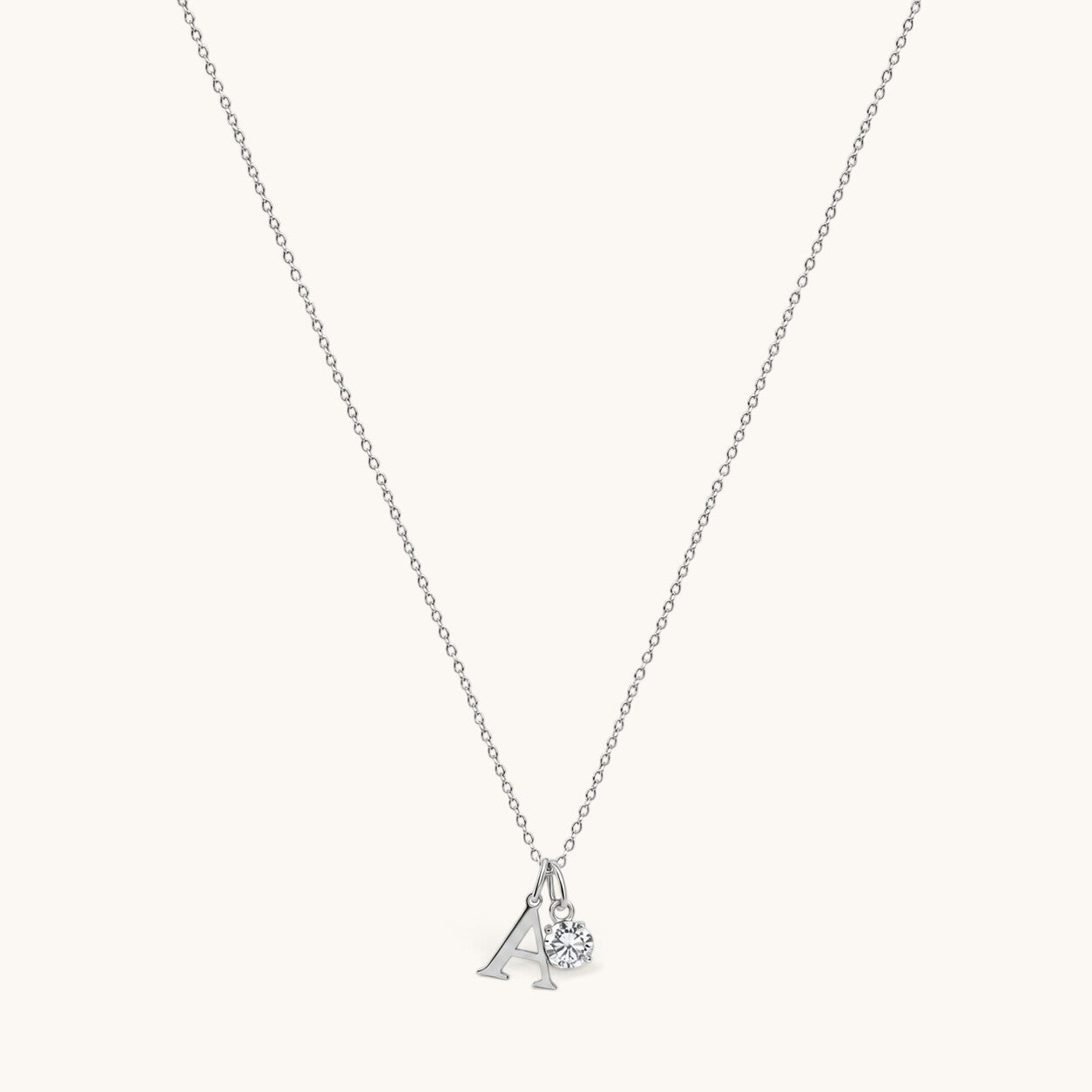 Nadare Co. silver initial A pendant necklace with a sparkling round birthstone charm on a delicate chain