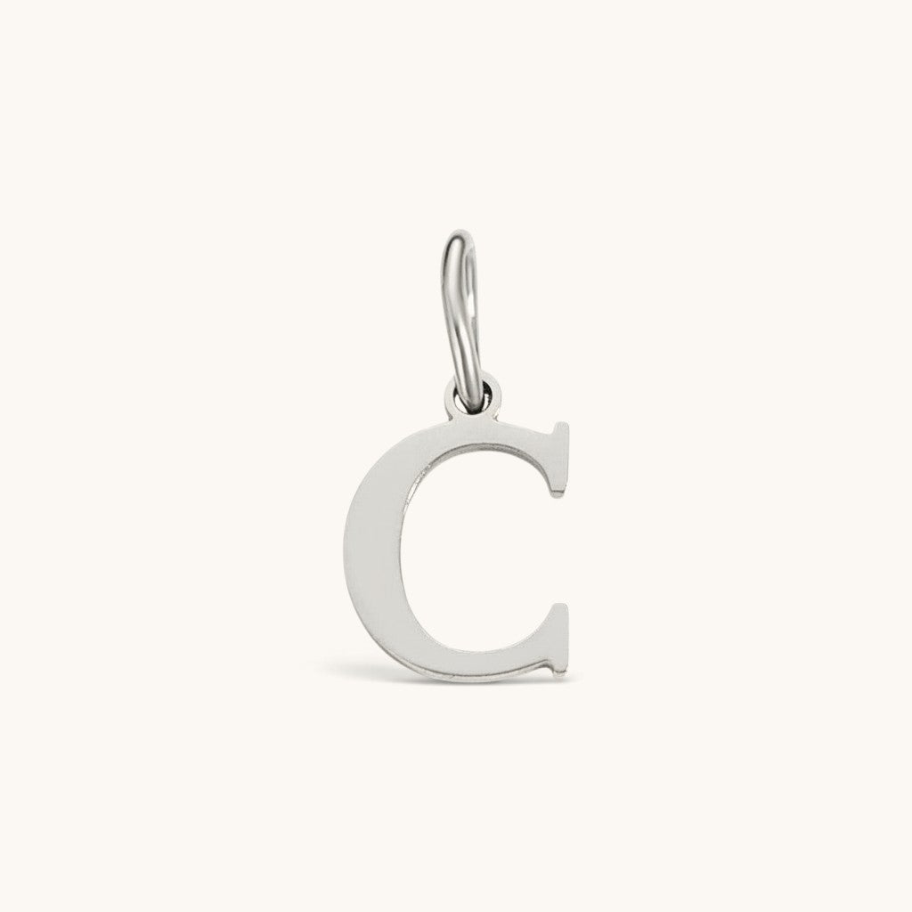 Nadare Co. silver-toned initial charm featuring a clean serif letter C for personalized jewelry layering.