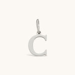 Nadare Co. silver-toned initial charm featuring a clean serif letter C for personalized jewelry layering.