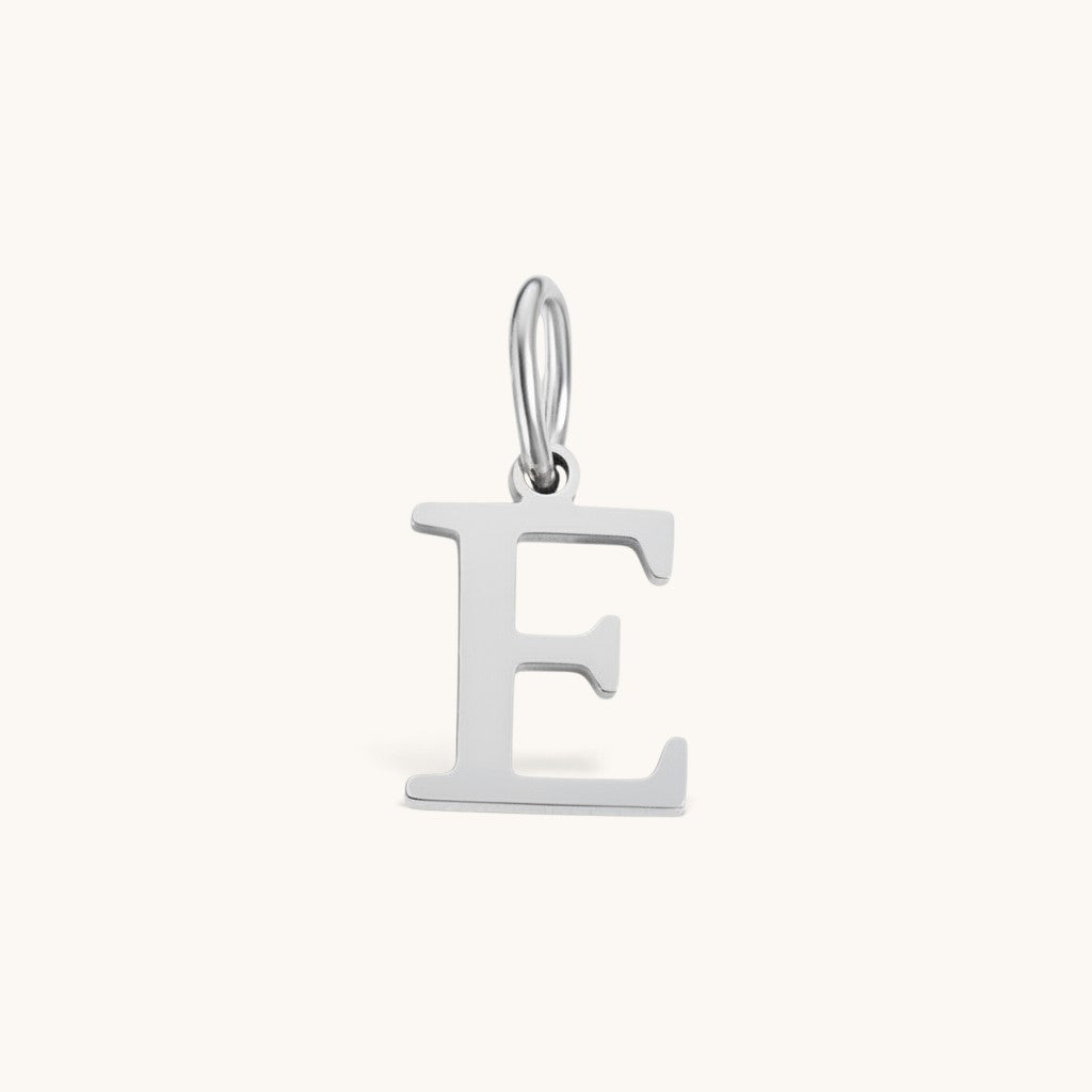 Nadare Co. silver-toned stainless steel initial E charm with a clean serif font for everyday jewelry layering.