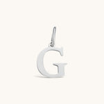 Nadare Co. silver-toned initial G charm with a clean serif font, crafted for everyday wear and necklace layering.