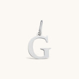 Nadare Co. silver-toned initial G charm with a clean serif font, crafted for everyday wear and necklace layering.