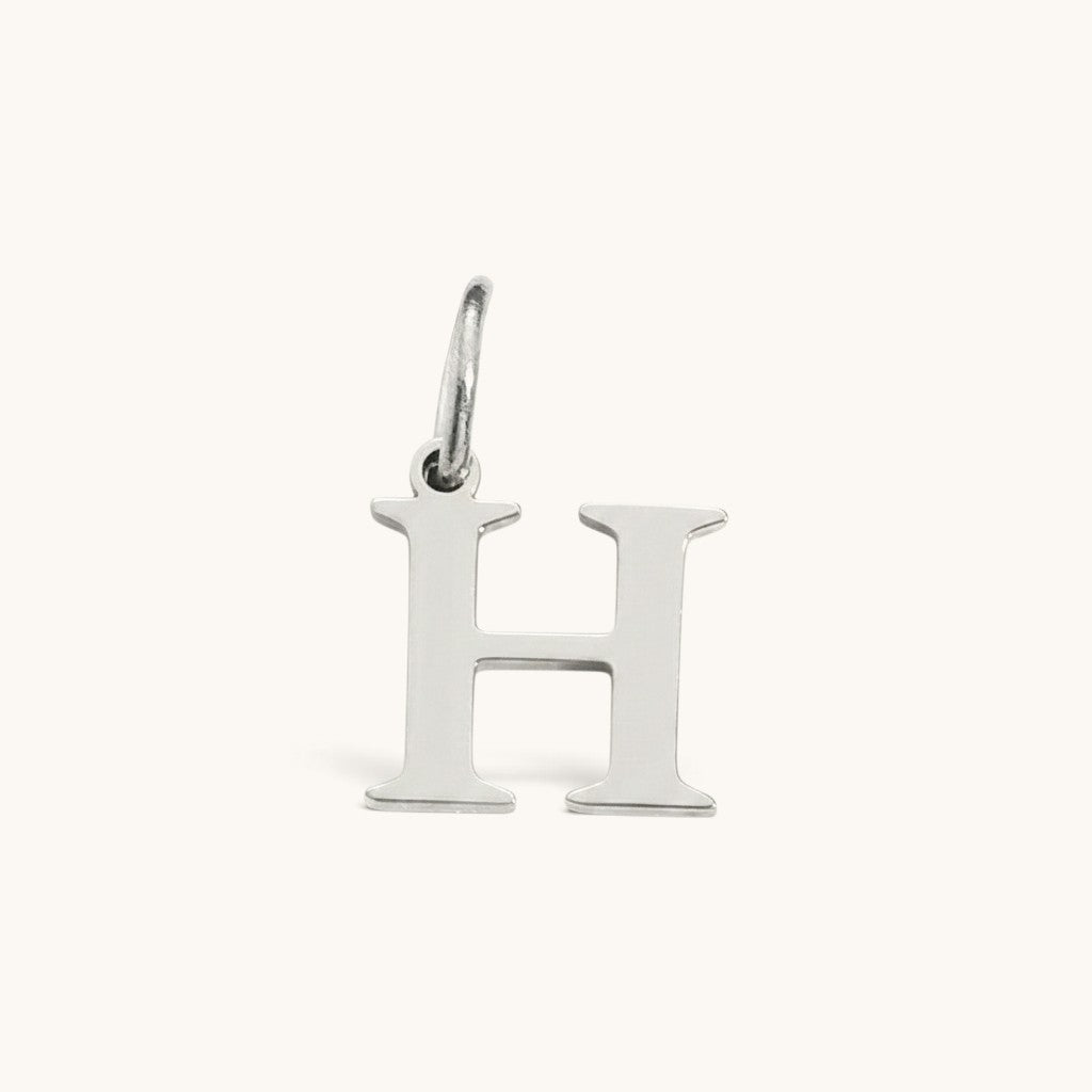 Nadare Co. silver-tone stainless steel initial H charm with a classic serif font design