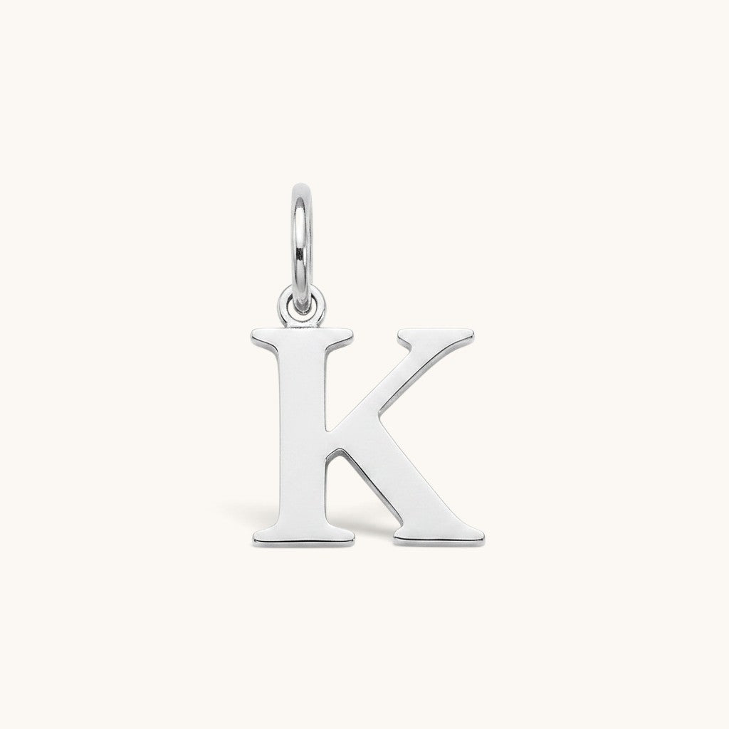 Nadare Co. silver-tone stainless steel initial K charm with a polished serif letter design