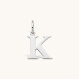 Nadare Co. silver-tone stainless steel initial K charm with a polished serif letter design
