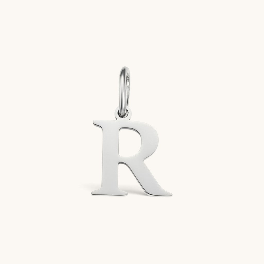 Nadare Co. silver-toned stainless steel initial R charm with a classic serif font design.