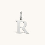Nadare Co. silver-toned stainless steel initial R charm with a classic serif font design.