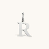 Nadare Co. silver-toned stainless steel initial R charm with a classic serif font design.