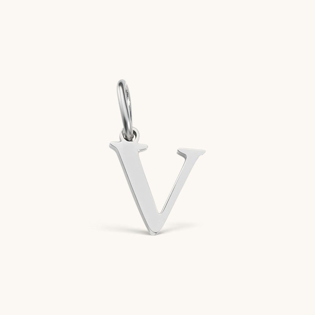 Nadare Co. silver-toned stainless steel letter V initial charm with a clean serif font design.
