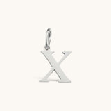 Nadare Co. silver-toned stainless steel letter X charm with a polished serif font design for necklace layering.