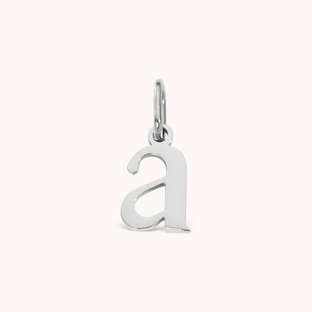 Nadare Co. silver-toned lowercase letter a charm made of stainless steel for everyday jewelry layering.