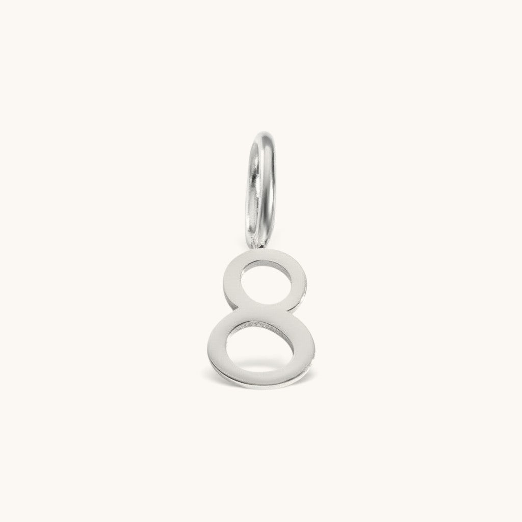 Nadare Co. silver-toned number 8 charm made from stainless steel for minimal everyday jewelry layering.