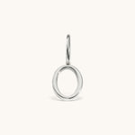 Nadare Co. silver-toned number zero charm made of stainless steel with a minimalist circular design.
