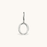 Nadare Co. silver-toned number zero charm made of stainless steel with a minimalist circular design.