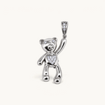 Nadare Co. silver teddy bear charm with cubic zirconia heart, eyes, and pavé bail on a neutral background.