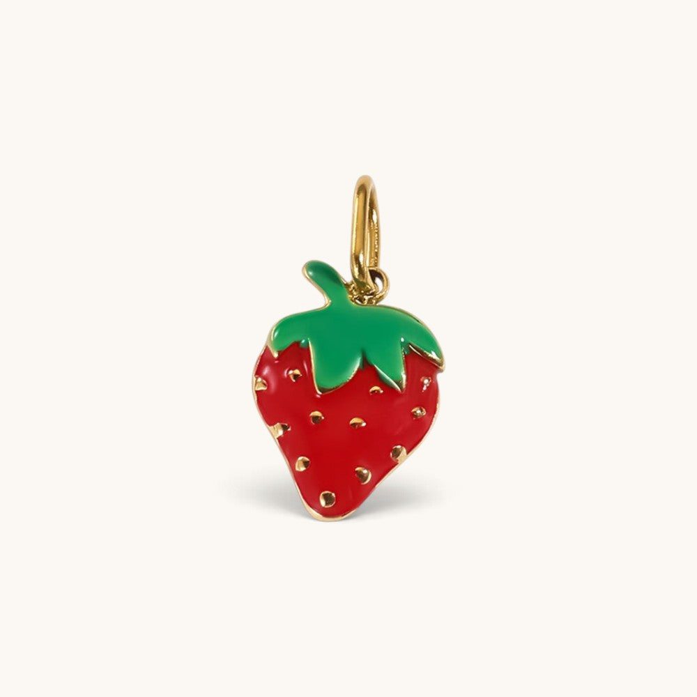 Nadare Co. strawberry charm with glossy red and green enamel and polished gold detailing on a white background