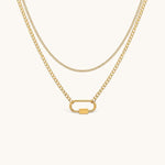 Nadare Co. Sylvie gold layered necklace featuring a delicate chain and a curb chain with a functional carabiner clasp.