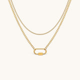 Nadare Co. Sylvie gold layered necklace featuring a delicate chain and a curb chain with a functional carabiner clasp.