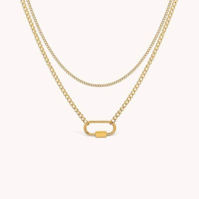 Nadare Co. Sylvie gold layered necklace featuring a delicate chain and a curb chain with a functional carabiner clasp.