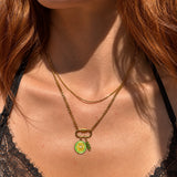Nadare Co. Sylvie gold layered necklace with a curb chain, delicate chain, and a lemon charm on a carabiner clasp