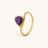 Nadare Co. Vela Birthstone Ring featuring a purple trillion-cut gemstone on a gold-plated stainless steel open band.