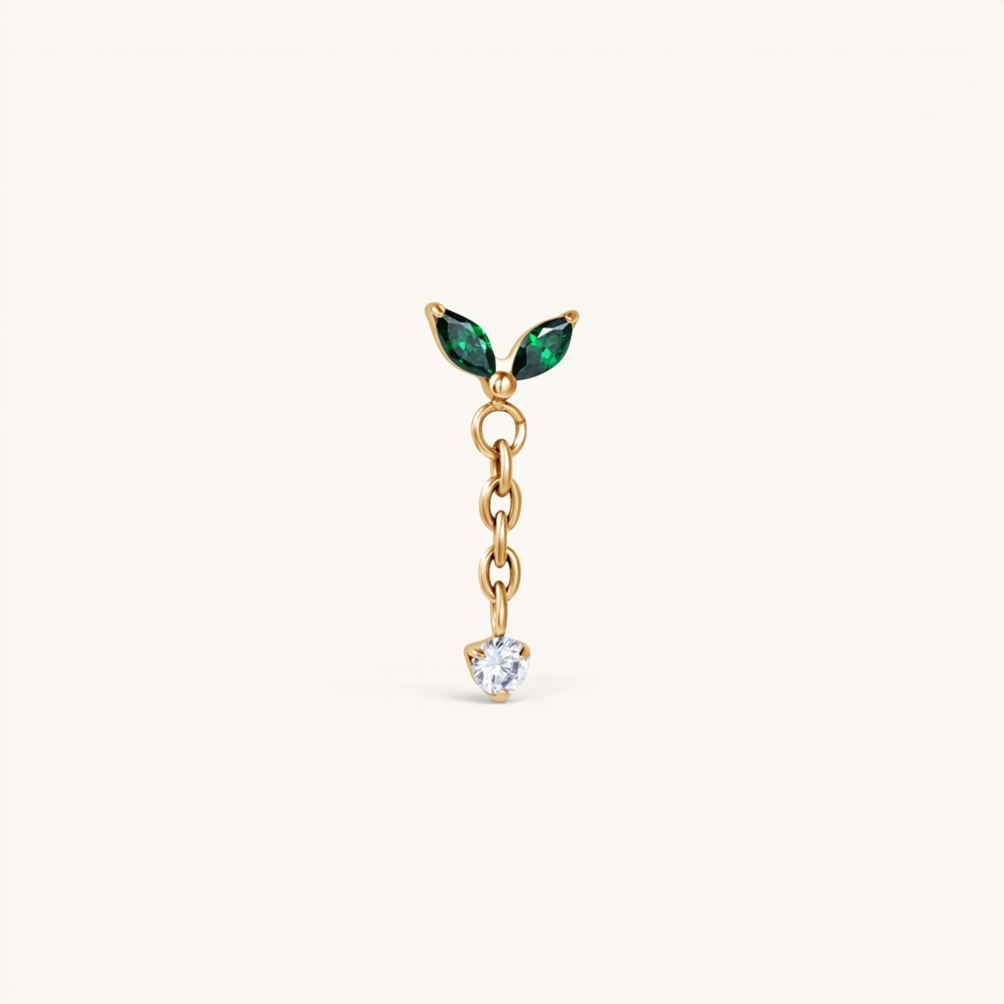 Nadare Co. Willow threadless piercing front in gold-plated titanium with emerald green marquise CZ and dangling clear CZ
