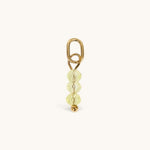 Nadare Co. birth month bead charm featuring three faceted pale yellow beads and a gold jump ring for necklaces.